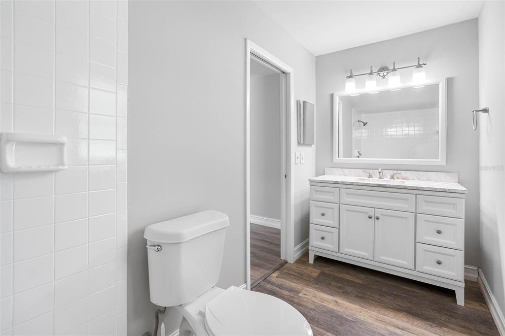 346 Ranch Road Tarpon Springs, FL 34688 - Photo 32 of 64 a bathroom with a toilet a sink and mirror