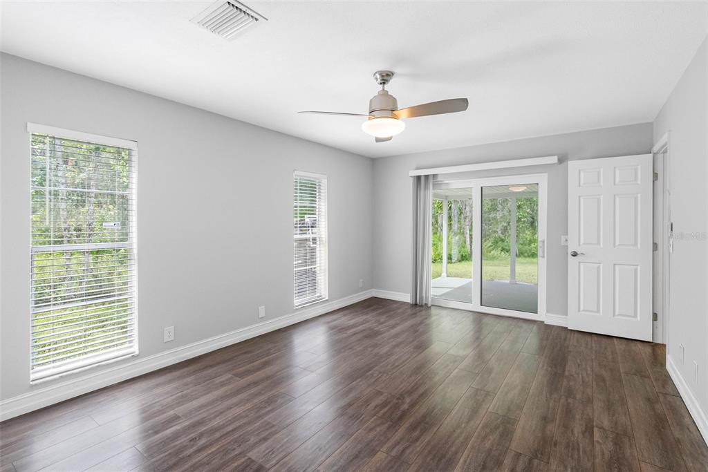 346 Ranch Road Tarpon Springs, FL 34688 - Photo 33 of 64 a view of an empty room with wooden floor and a window