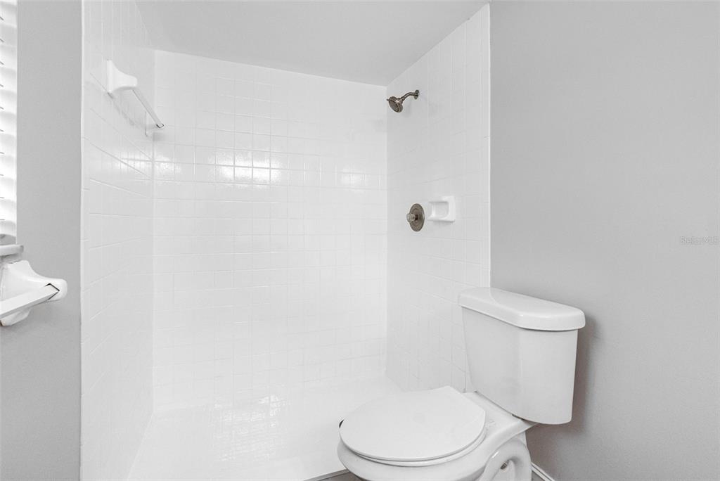 346 Ranch Road Tarpon Springs, FL 34688 - Photo 34 of 64 a white toilet sitting next to a shower