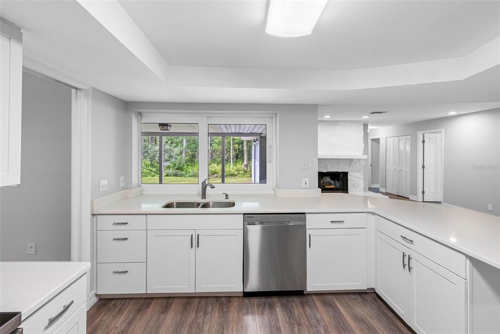 346 Ranch Road Tarpon Springs, FL 34688 - Photo 36 of 64 a kitchen with white cabinets sink and window