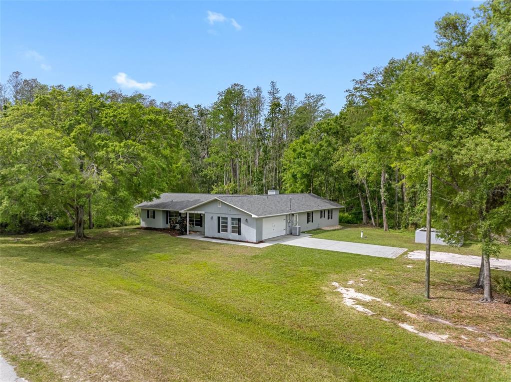 346 Ranch Road Tarpon Springs, FL 34688 - Photo 4 of 64 a view of a house with swimming pool and a yard