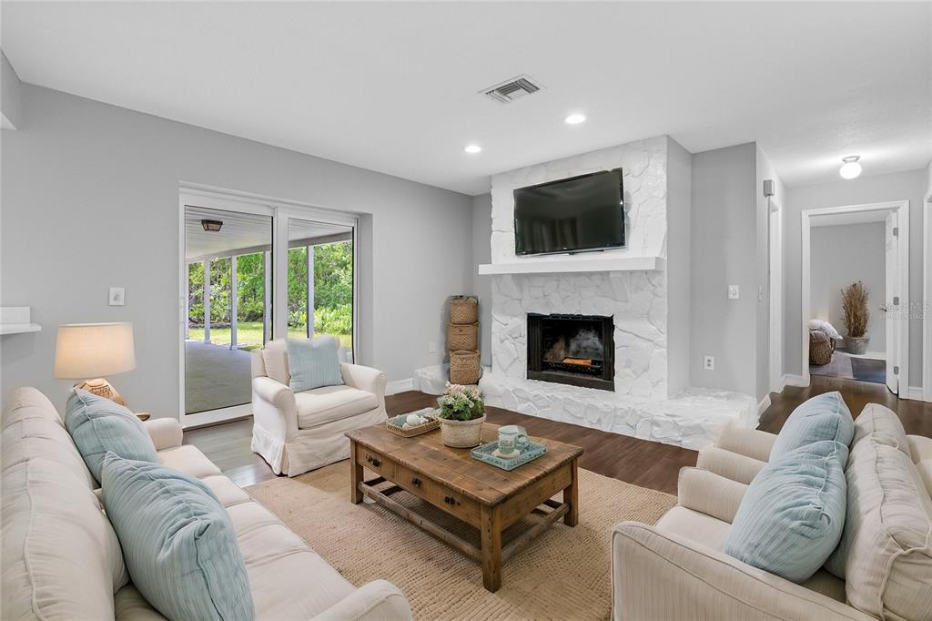 346 Ranch Road Tarpon Springs, FL 34688 - Photo 47 of 64 a living room with furniture a flat screen tv and a fireplace