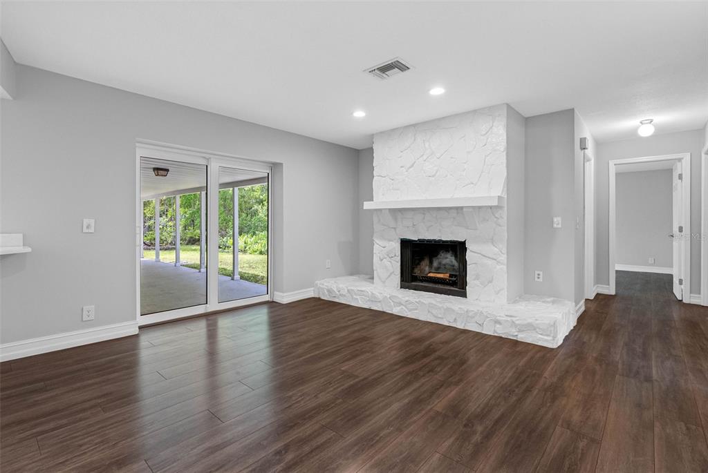 346 Ranch Road Tarpon Springs, FL 34688 - Photo 50 of 64 a view of an empty room with wooden floor and a window