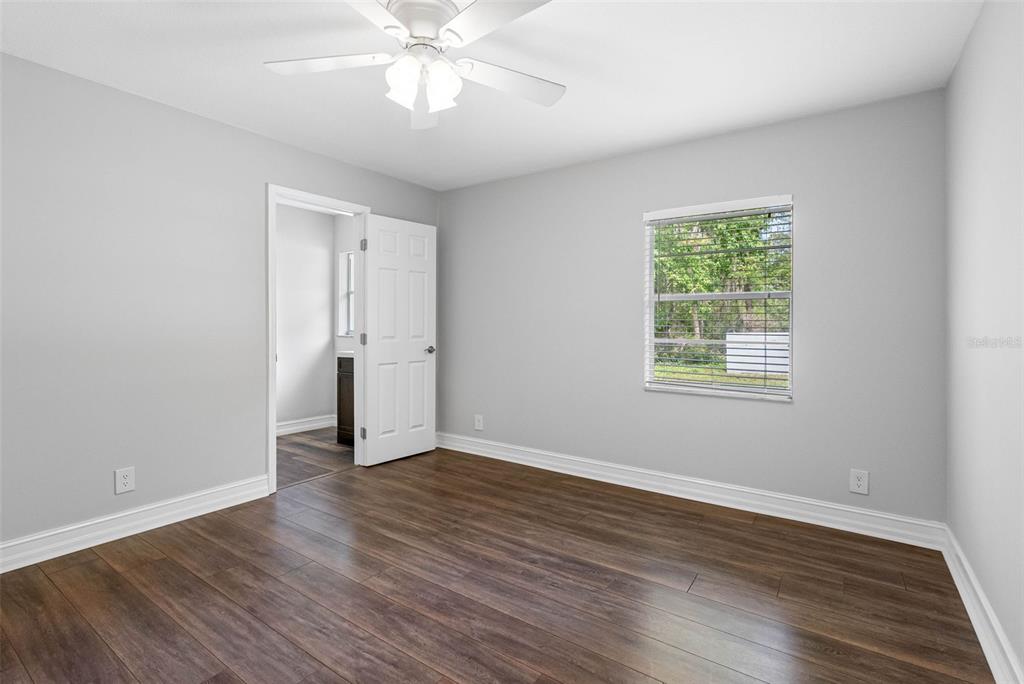 346 Ranch Road Tarpon Springs, FL 34688 - Photo 52 of 64 a view of an empty room with wooden floor and a window