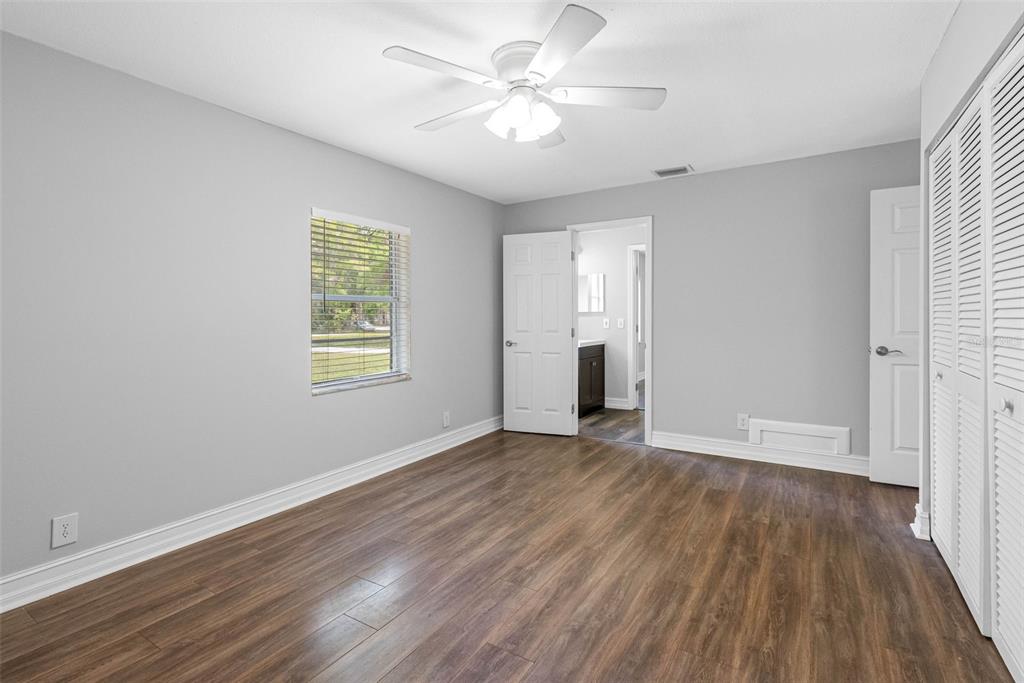 346 Ranch Road Tarpon Springs, FL 34688 - Photo 56 of 64 an empty room with wooden floor and windows