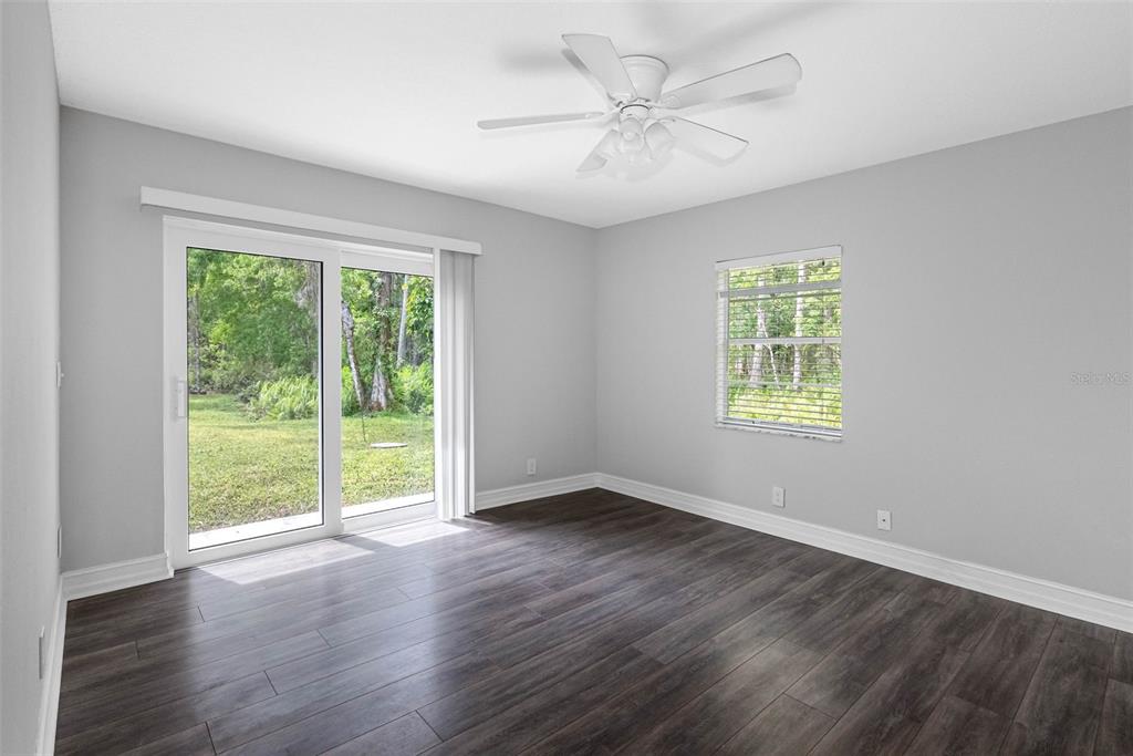 346 Ranch Road Tarpon Springs, FL 34688 - Photo 60 of 64 a view of an empty room with a window and wooden floor