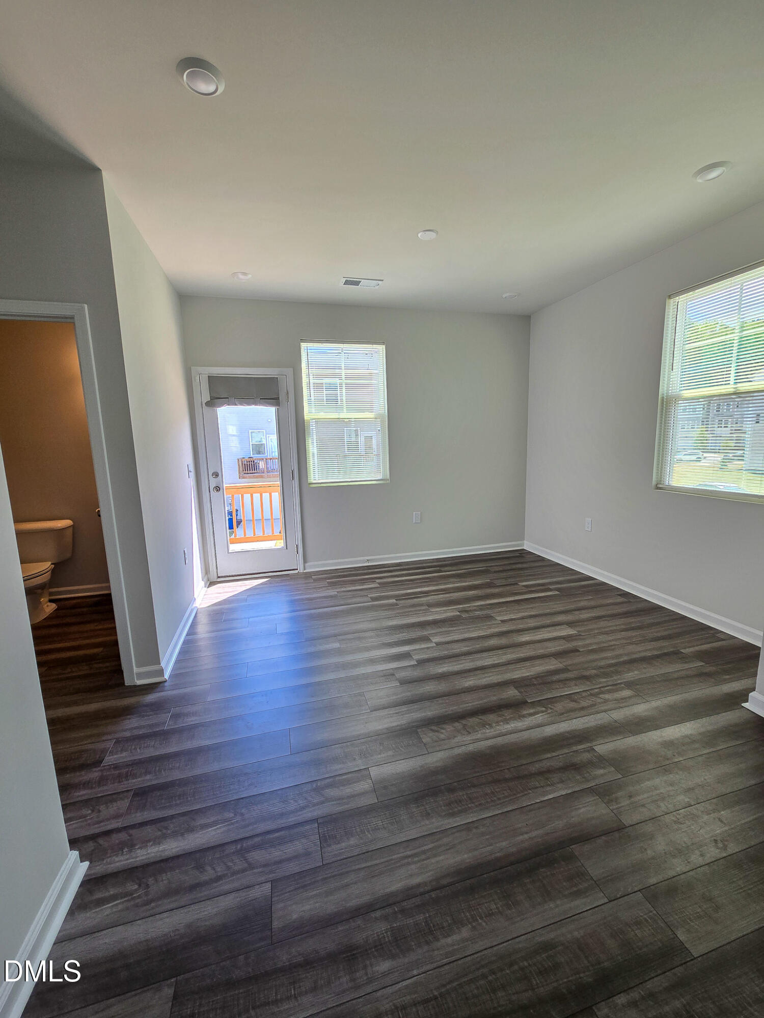 2431 Kasota Lane Raleigh, NC 27610 - Photo 21 of 46 wooden floor in an empty room with a window