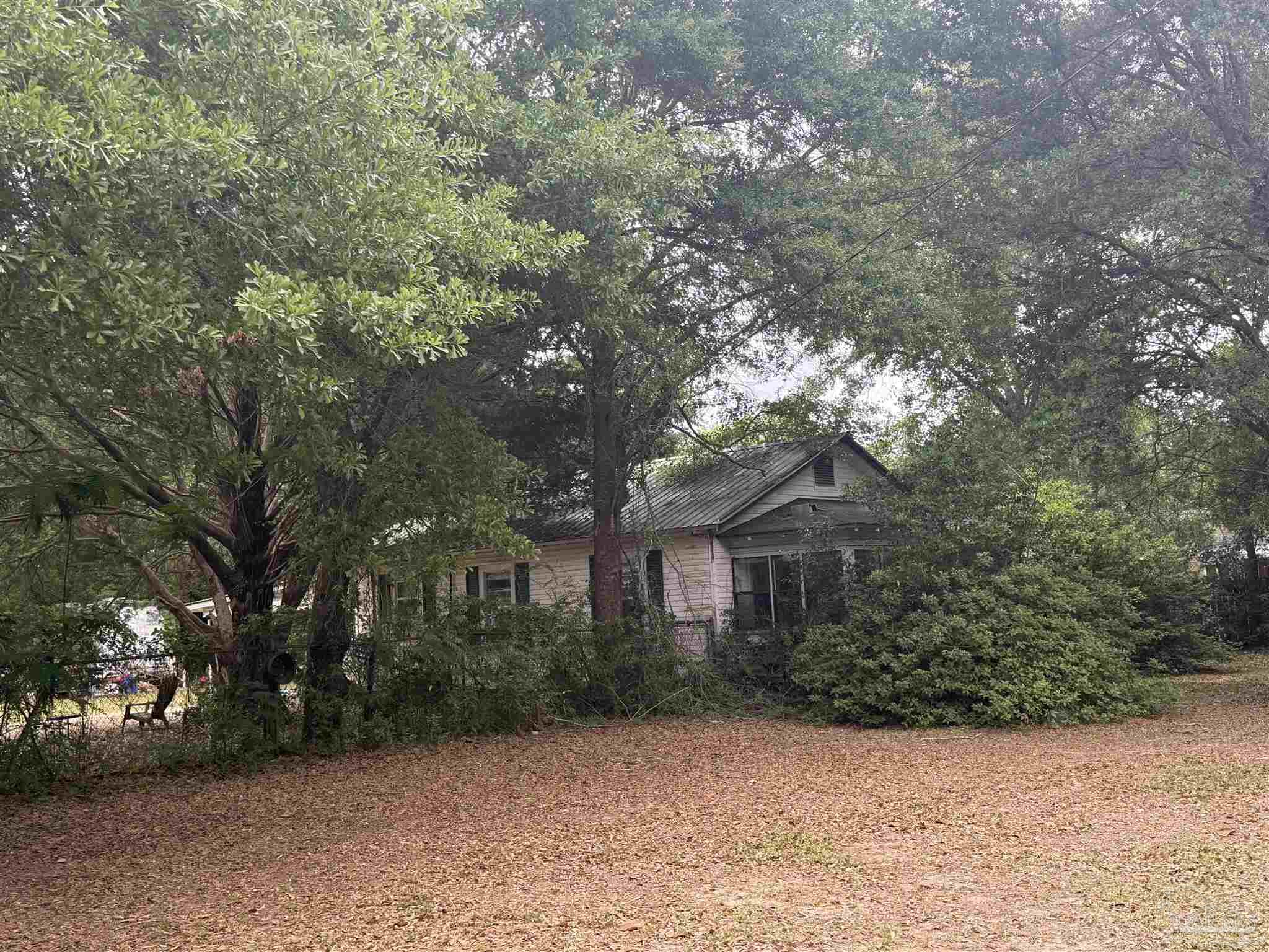6042 Enfinger Road Pace, FL 32571 - Photo 1 of 10 a front view of a house with a yard