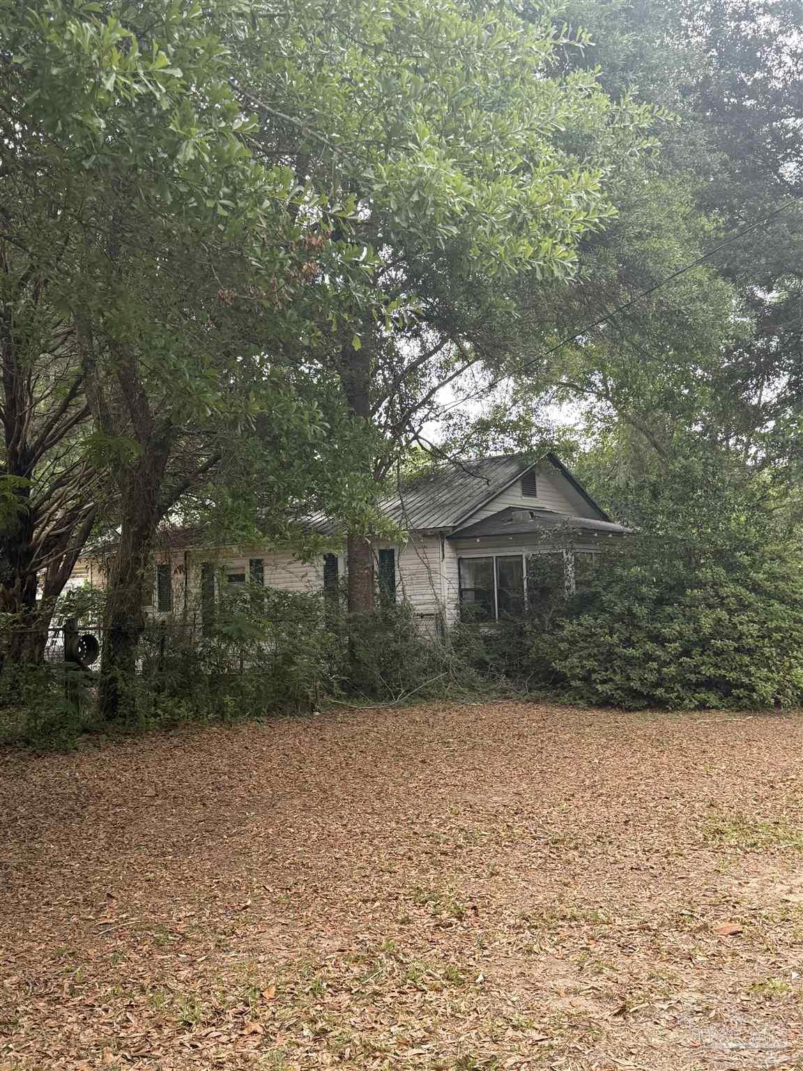 6042 Enfinger Road Pace, FL 32571 - Photo 3 of 10 a front view of house with yard and trees