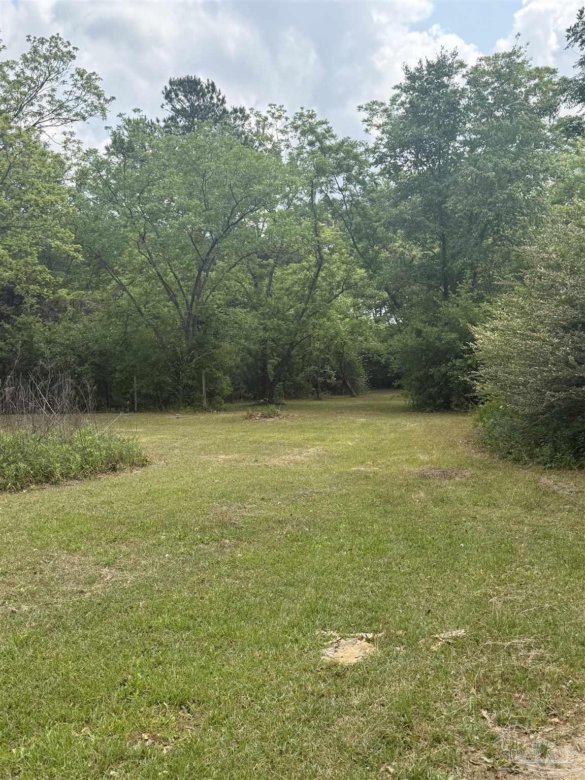 6042 Enfinger Road Pace, FL 32571 - Photo 6 of 10 a view of a field with an outdoor space