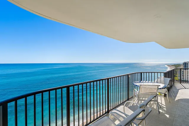 a view of balcony with wooden floor and seating space