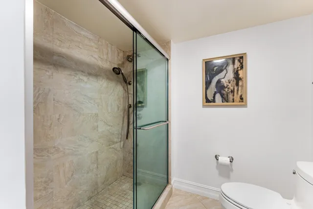 a white toilet sitting next to a bathroom sink