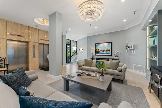 a living room with furniture and a chandelier