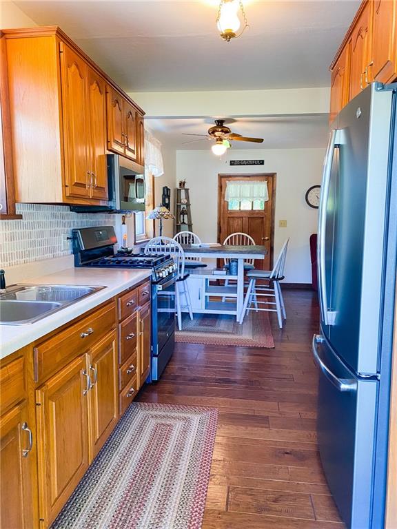 537 Fleming Road Sarver, PA 16055 - Photo 10 of 20 a kitchen with stainless steel appliances granite countertop a refrigerator a sink dishwasher a stove top oven a dining table and chairs with wooden floor