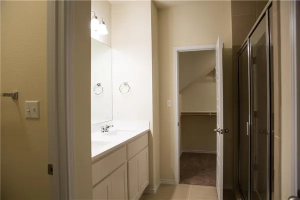 a bathroom with a glass door shower