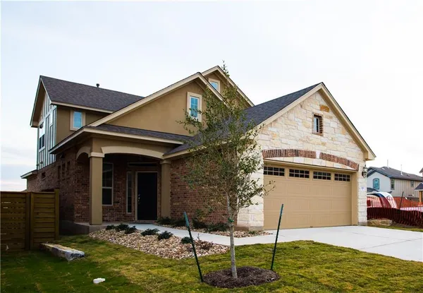 a front view of house with a yard and garage