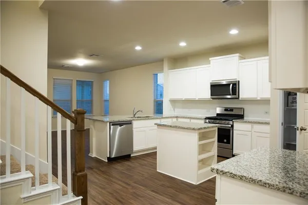 a kitchen that has a sink and a stove top oven