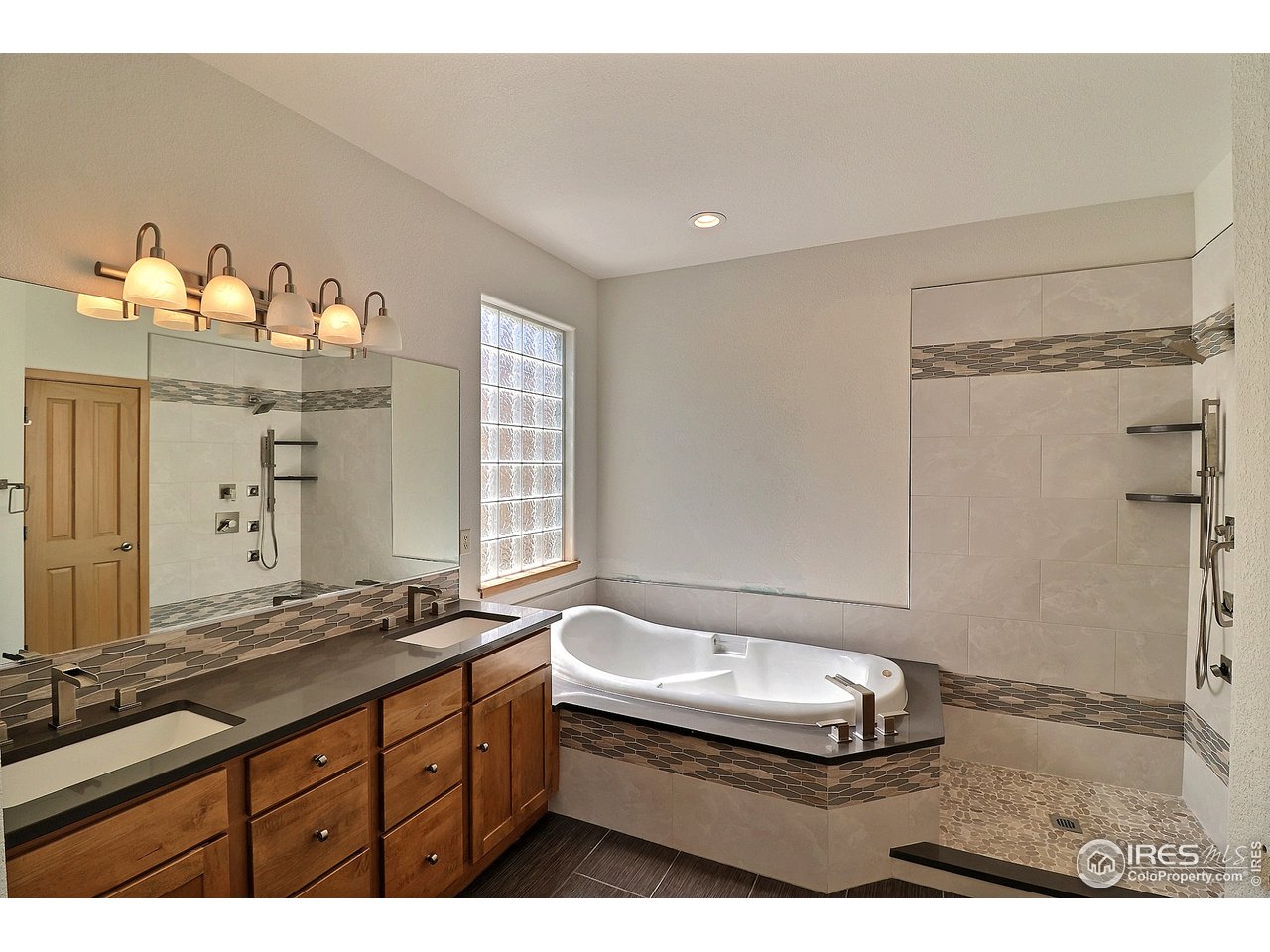 7205 Poudre River Road, Unit 3 Greeley, CO 80634 - Photo 14 of 27 Primary bath is so elegant with Quartz countertops and soaker tub surround