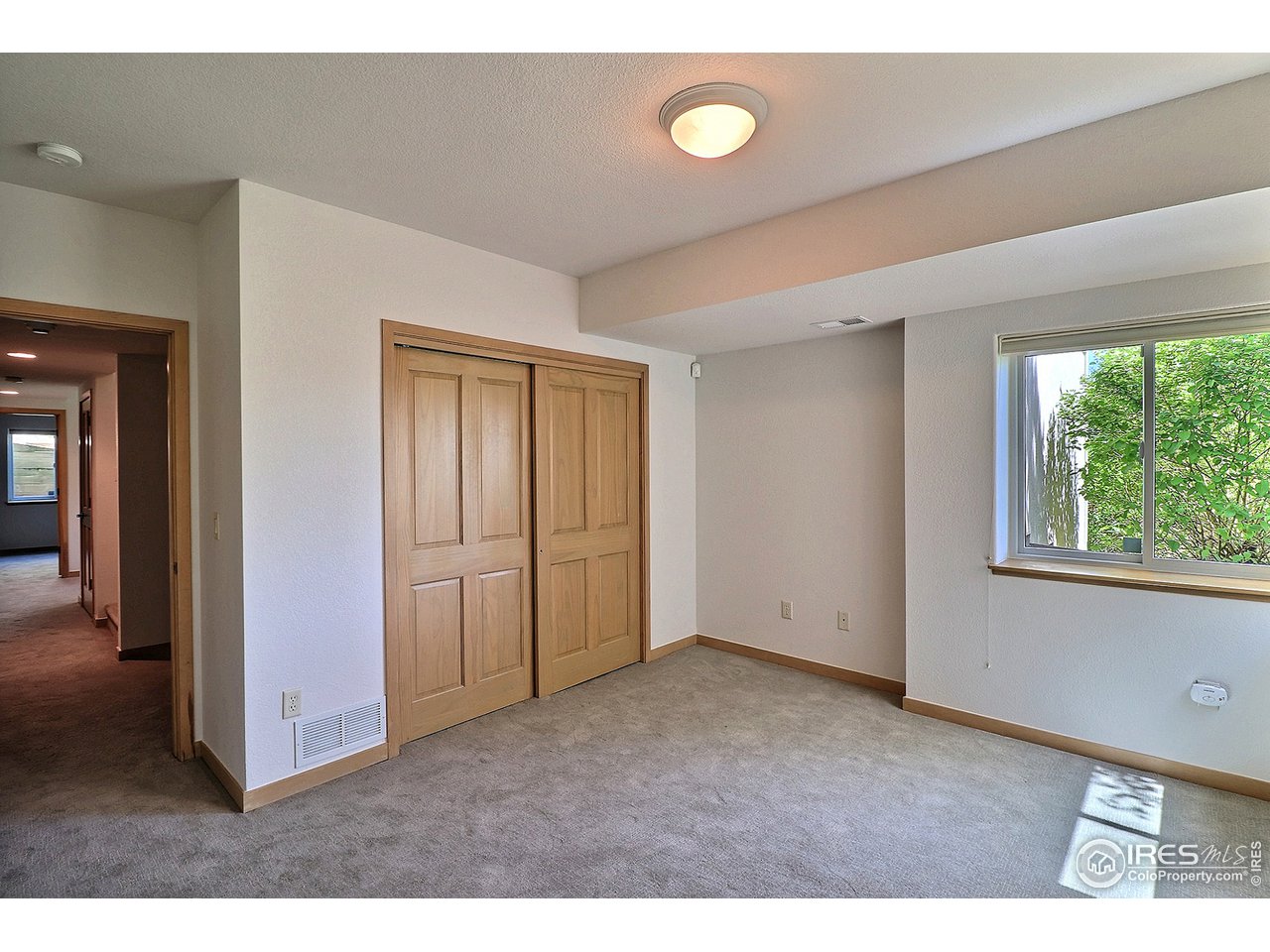 7205 Poudre River Road, Unit 3 Greeley, CO 80634 - Photo 21 of 27 Bedroom 3 in basement has corner windows that add charm and light.