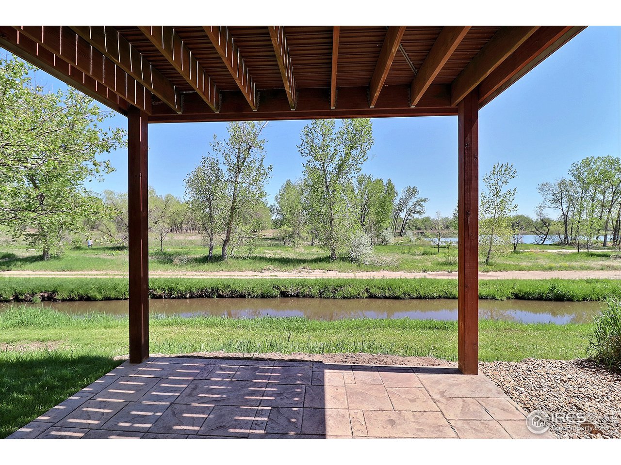 7205 Poudre River Road, Unit 3 Greeley, CO 80634 - Photo 24 of 27 Walk out covered patio off of Family room--Right to the river and trails!