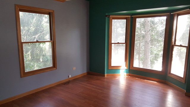 1102 Gulf Keys Road Streamwood, IL 60120 - Photo 12 of 25 a view of an empty room with wooden floor and a window