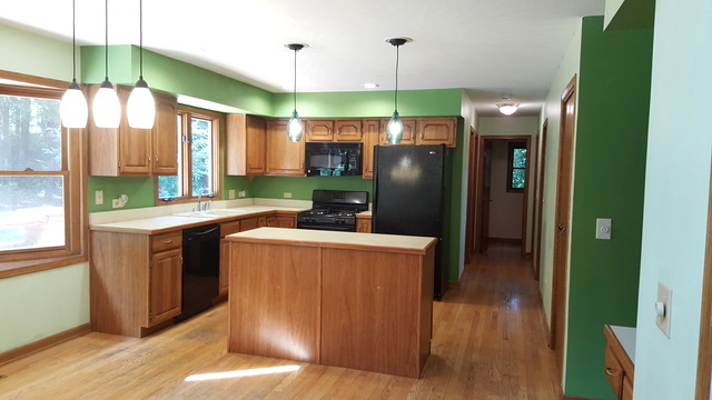 1102 Gulf Keys Road Streamwood, IL 60120 - Photo 4 of 25 a kitchen with stainless steel appliances granite countertop a refrigerator a sink a stove and a wooden floors