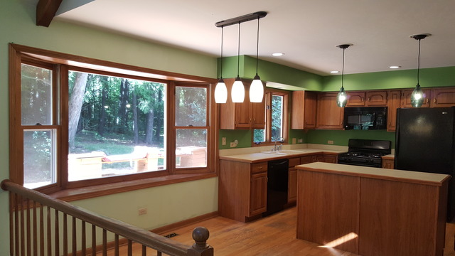1102 Gulf Keys Road Streamwood, IL 60120 - Photo 6 of 25 a kitchen with kitchen island a large window in it