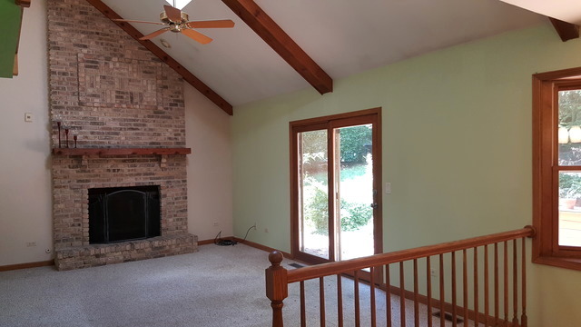 1102 Gulf Keys Road Streamwood, IL 60120 - Photo 7 of 25 a view of a livingroom with fireplace and stairs