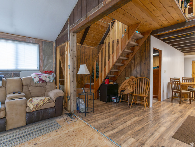 5082 Pine Crest Road Evanston, UT 82930 - Photo 14 of 25 Wood-finish flooring throughout, featuring a natural wood staircase with open risers and a wood plank accent wall
