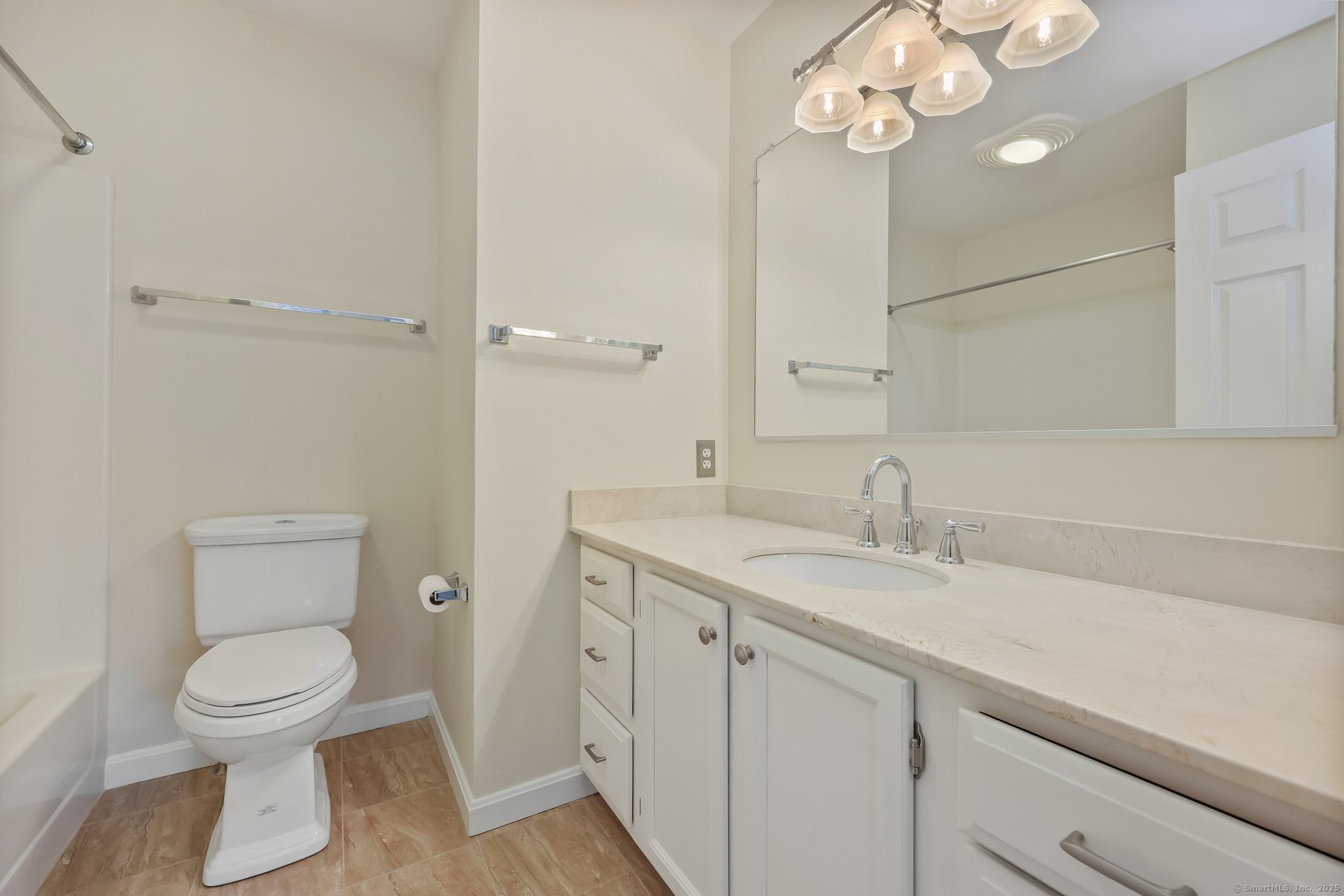 105 Dean Street, Unit A Stamford, CT 06902 - Photo 12 of 16 a bathroom with a toilet sink and mirror
