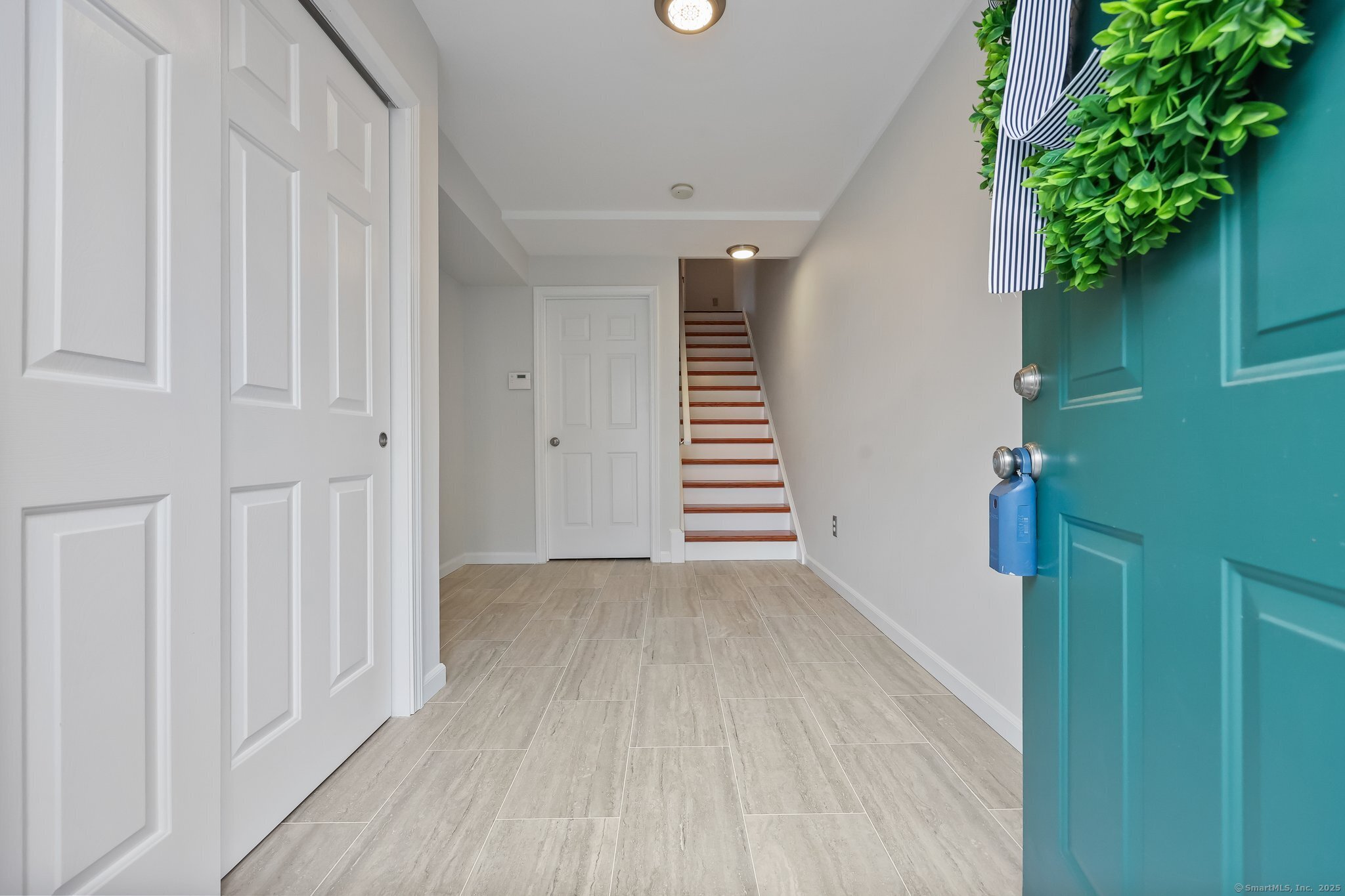 105 Dean Street, Unit A Stamford, CT 06902 - Photo 14 of 16 a view of a hallway with wooden floor and entryway