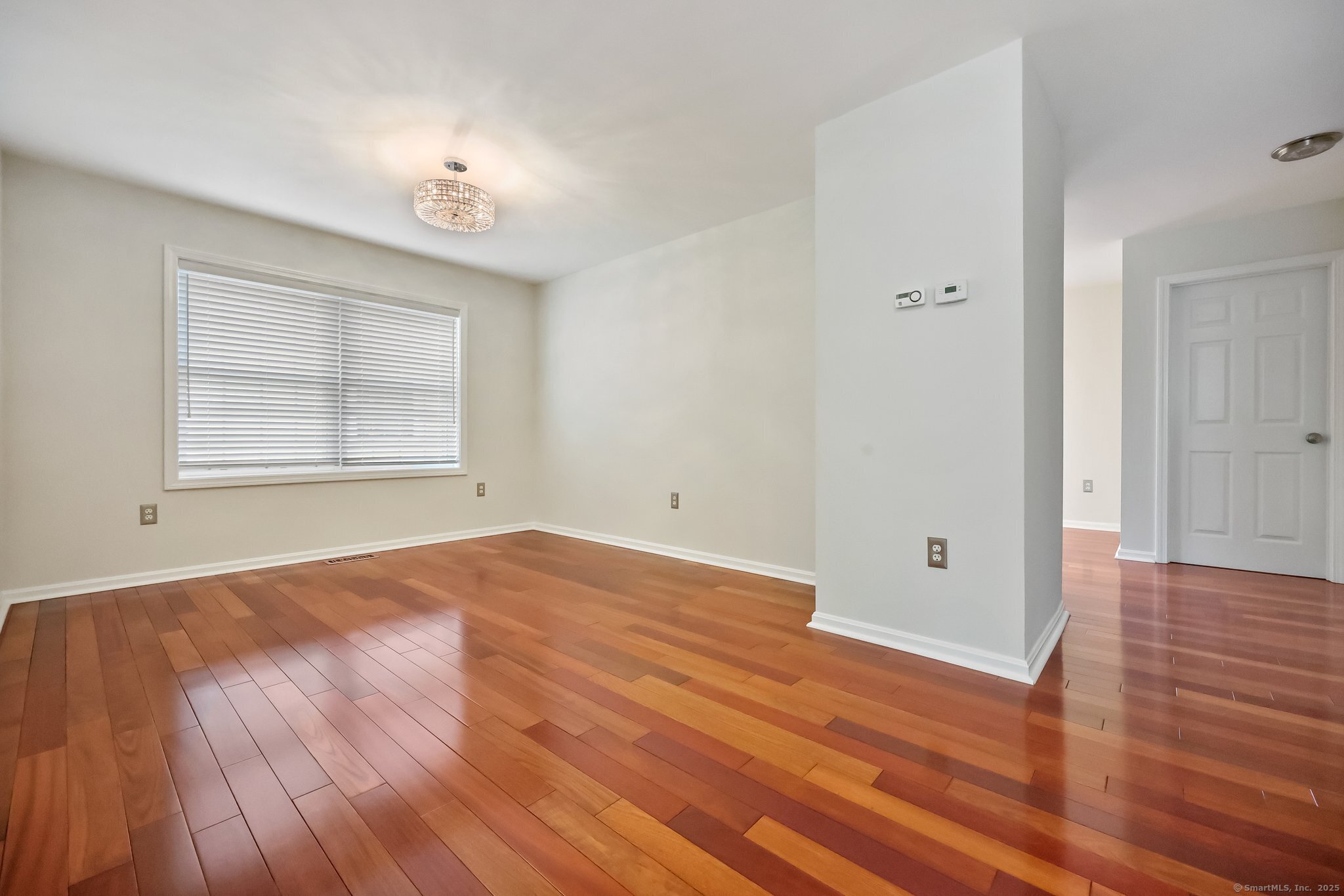 105 Dean Street, Unit A Stamford, CT 06902 - Photo 4 of 16 a view of an empty room with wooden floor and a window