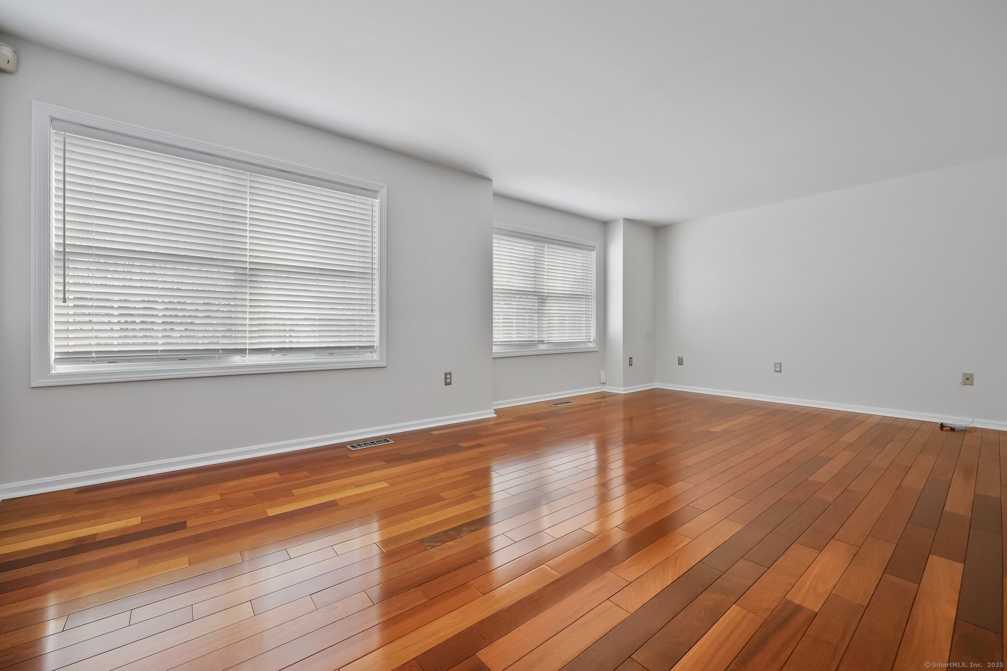 105 Dean Street, Unit A Stamford, CT 06902 - Photo 5 of 16 a view of empty room with wooden floor and fan