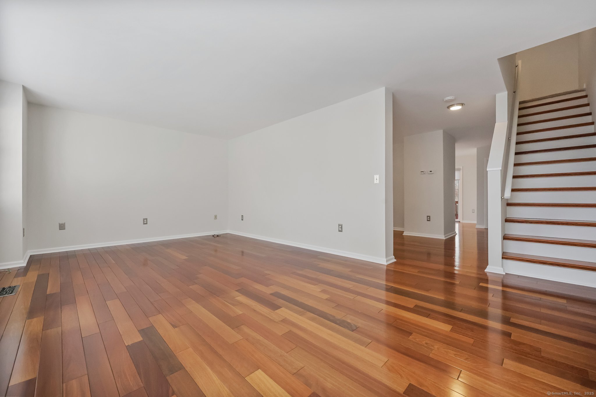 105 Dean Street, Unit A Stamford, CT 06902 - Photo 6 of 16 a view of a room with wooden floor and white walls