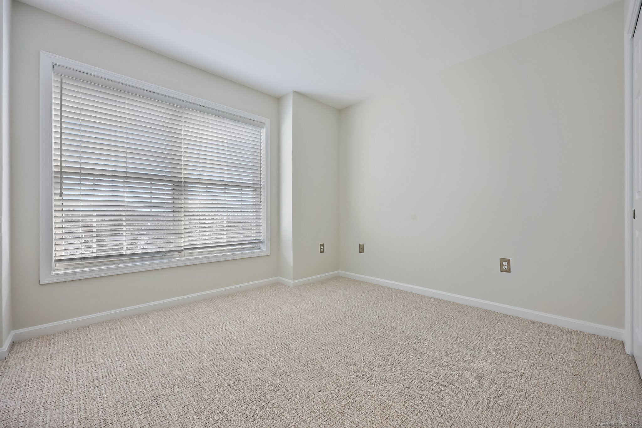 105 Dean Street, Unit A Stamford, CT 06902 - Photo 10 of 16 a view of an empty room with a window