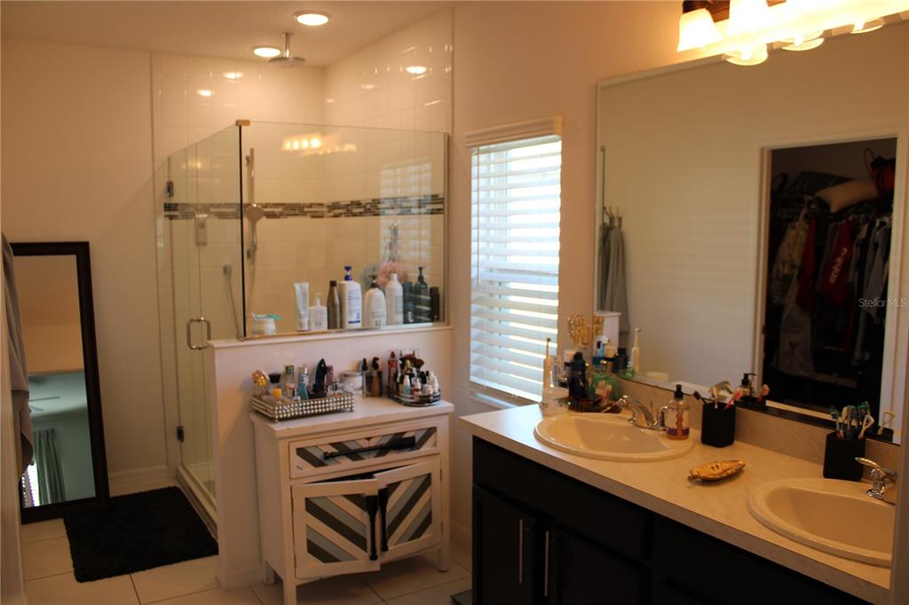 2591 Wadeview Loop St. Cloud, FL 34769 - Photo 11 of 18 a bathroom with a sink double vanity and a mirror