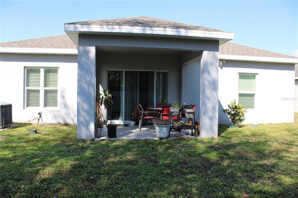 2591 Wadeview Loop St. Cloud, FL 34769 - Photo 17 of 18 a view of a house with yard and sitting area
