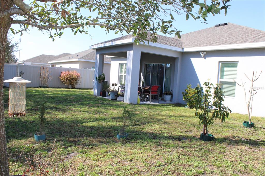 2591 Wadeview Loop St. Cloud, FL 34769 - Photo 18 of 18 a view of a house with a yard