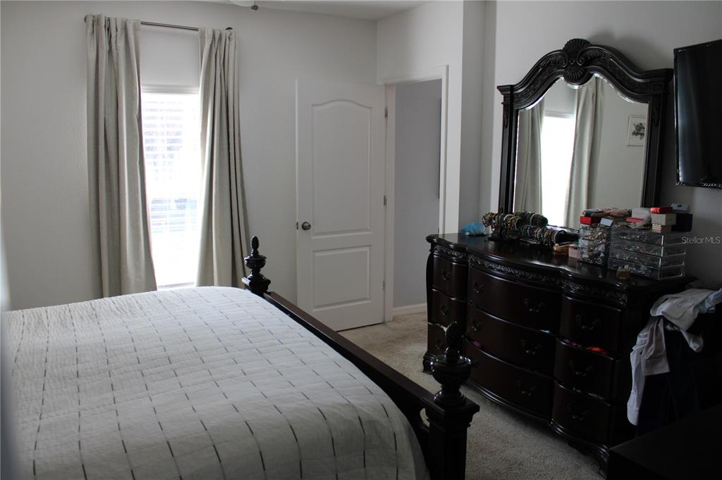 2591 Wadeview Loop St. Cloud, FL 34769 - Photo 9 of 18 a bedroom with a bed and a mirror