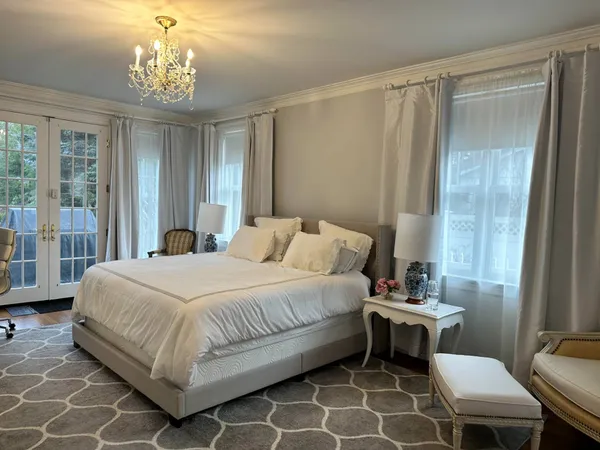 a bedroom with a bed and a table chair