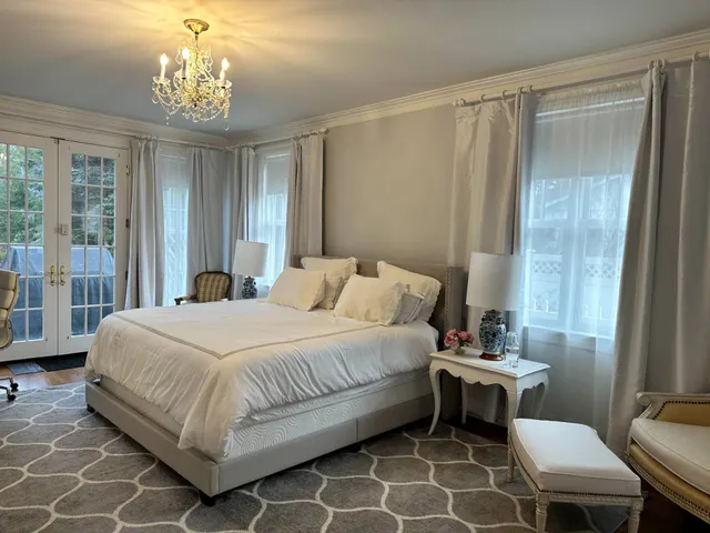 a bedroom with a bed and a table chair