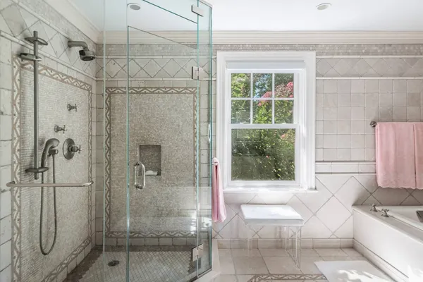 a bathroom with a tub shower and sink