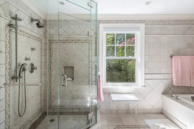 a bathroom with a tub shower and sink