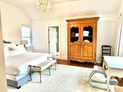 a spacious bedroom with a bed and a window