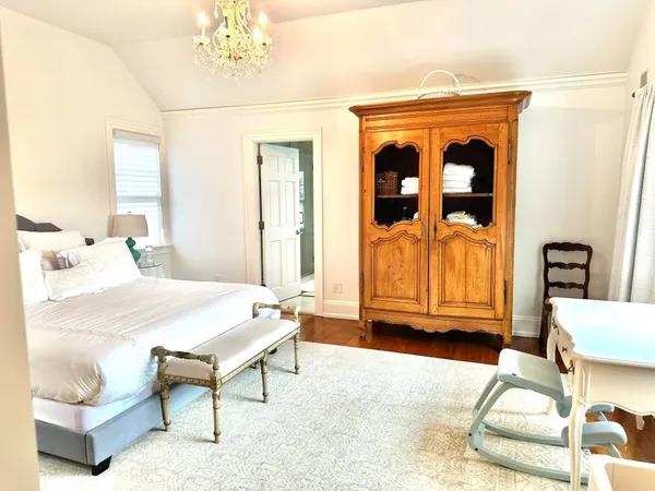 a spacious bedroom with a bed and a window