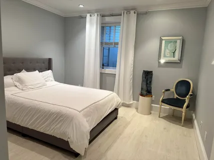 a bedroom with a bed and a chair