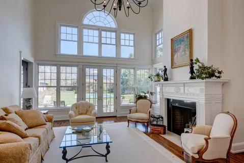 a living room with furniture a fireplace and a large window