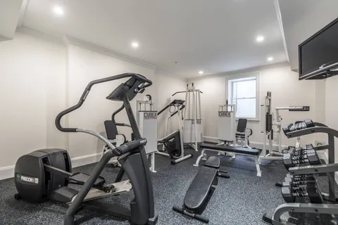 a room with gym equipment and windows