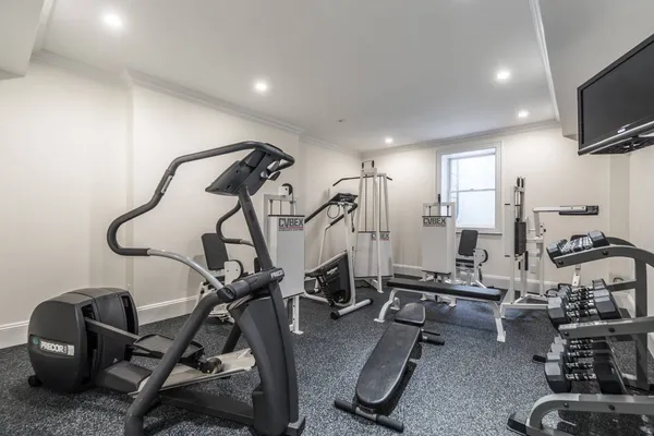 a room with gym equipment and windows