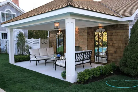 a view of a chair and table in backyard of the house